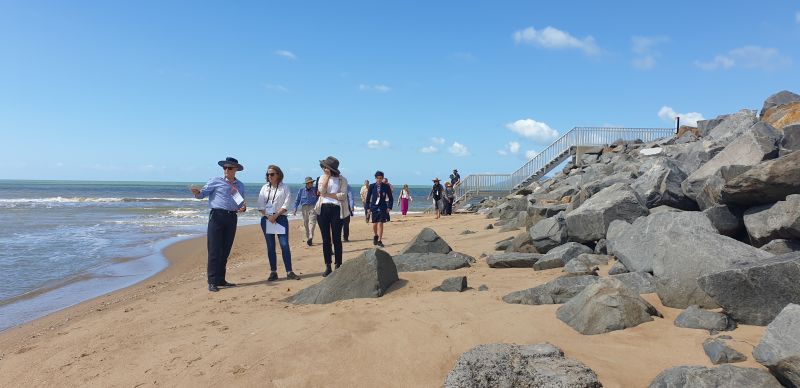 coastal managers near rock wall.