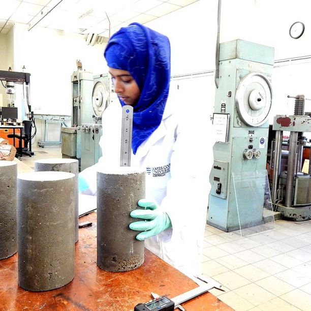 Student working with a cement sample in a lab