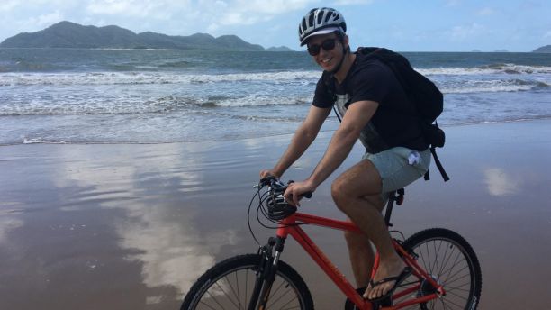 Sam riding his bike on the beach