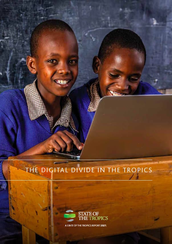 Cover image of The Digital Divide in the Tropics. Two boys in Kenya sit at a desk with a computer
