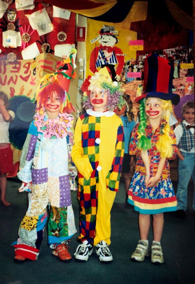Three children dressed as clowns