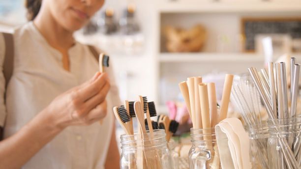 Woman shopping for bamboo toothbrushes and straws