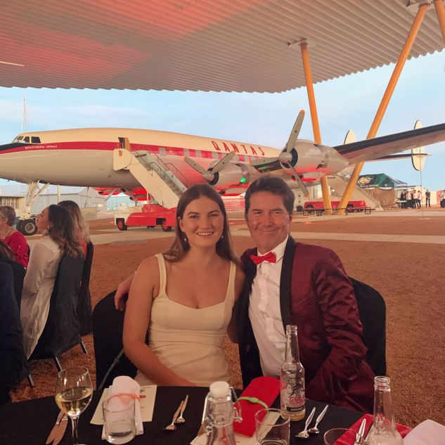 Two people at dinner in front of plane