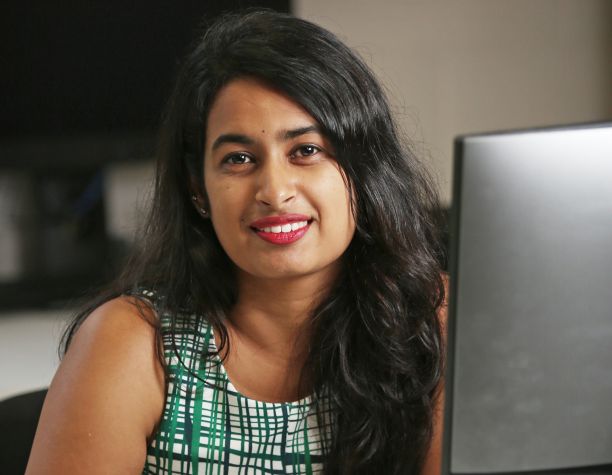 Rishitha Asam sitting at a computer. 