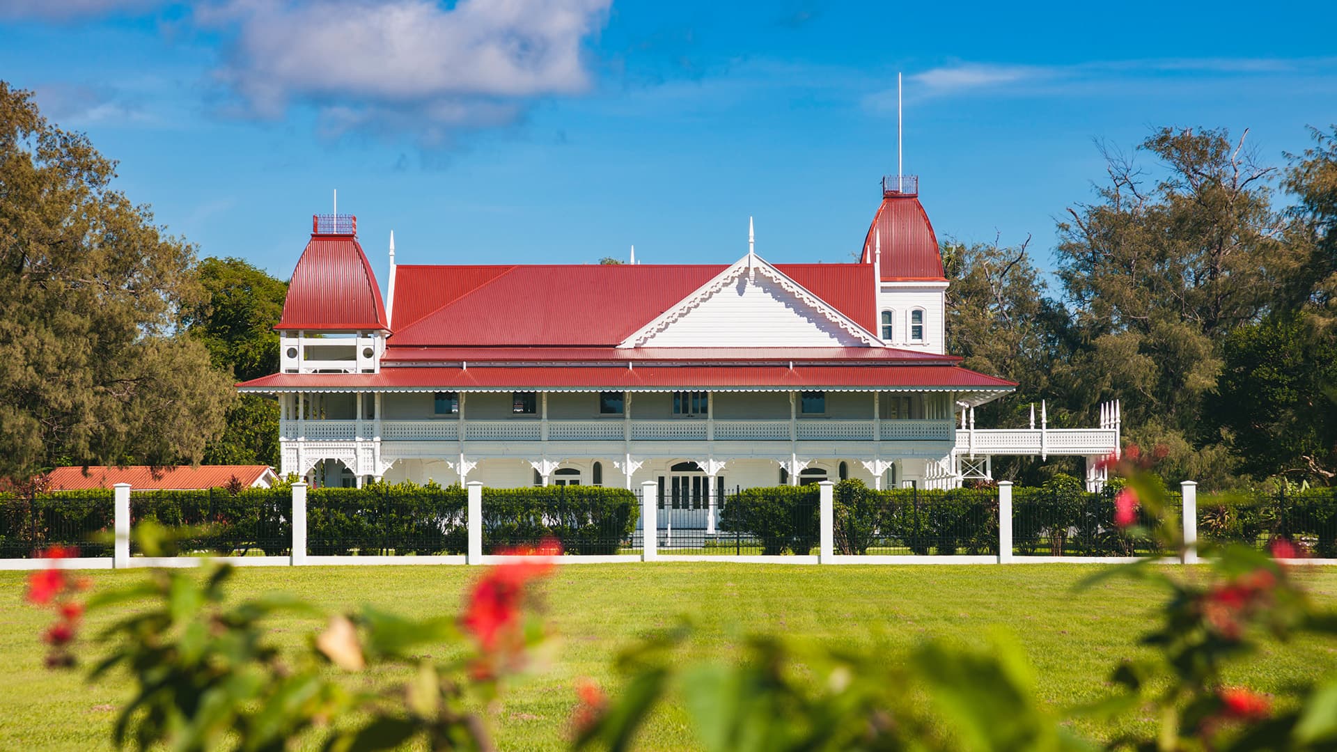 A photo of the Royal Palace in Tonga including green grass and blue sky