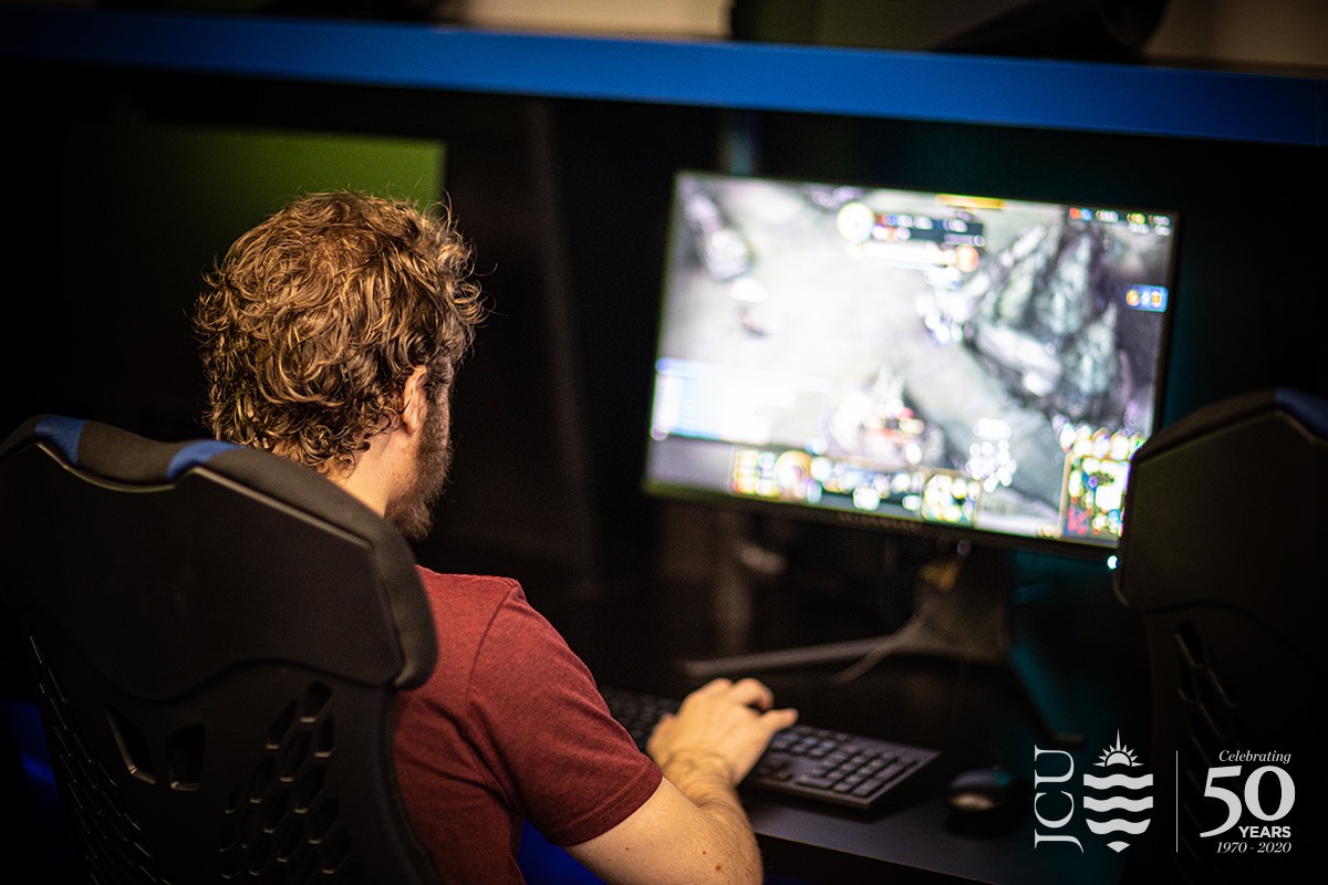 A rear view of a student mid-play in the JCU eSports room