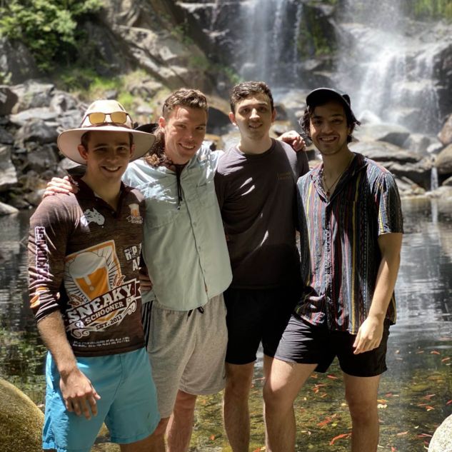 Sam and his mates in front of a waterfall
