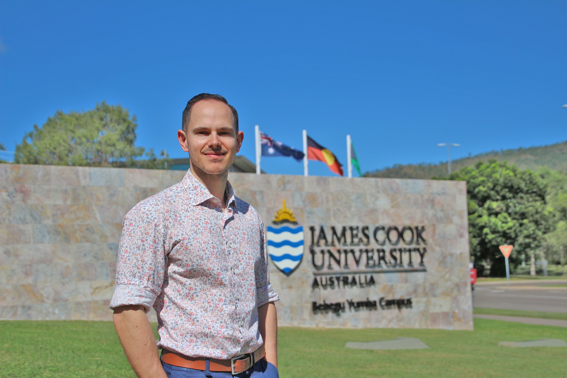 Andrew Trapp in front of JCU Townsville sign