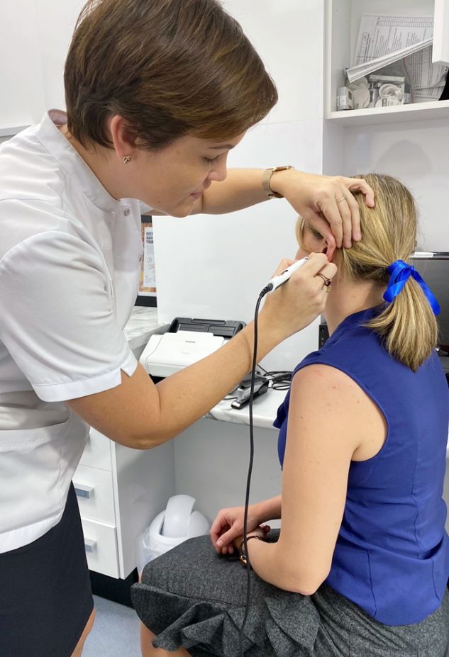 Pharmacist conducts an ear examination