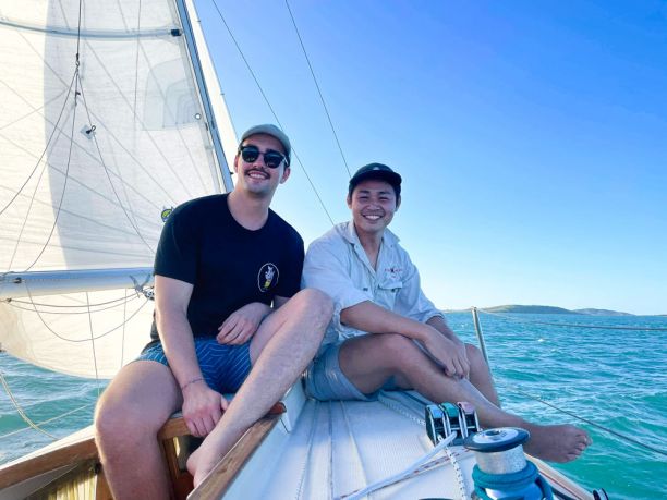 Two men on yacht smiling
