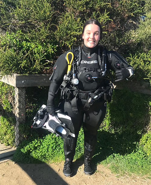 Courtney standing in diving gear
