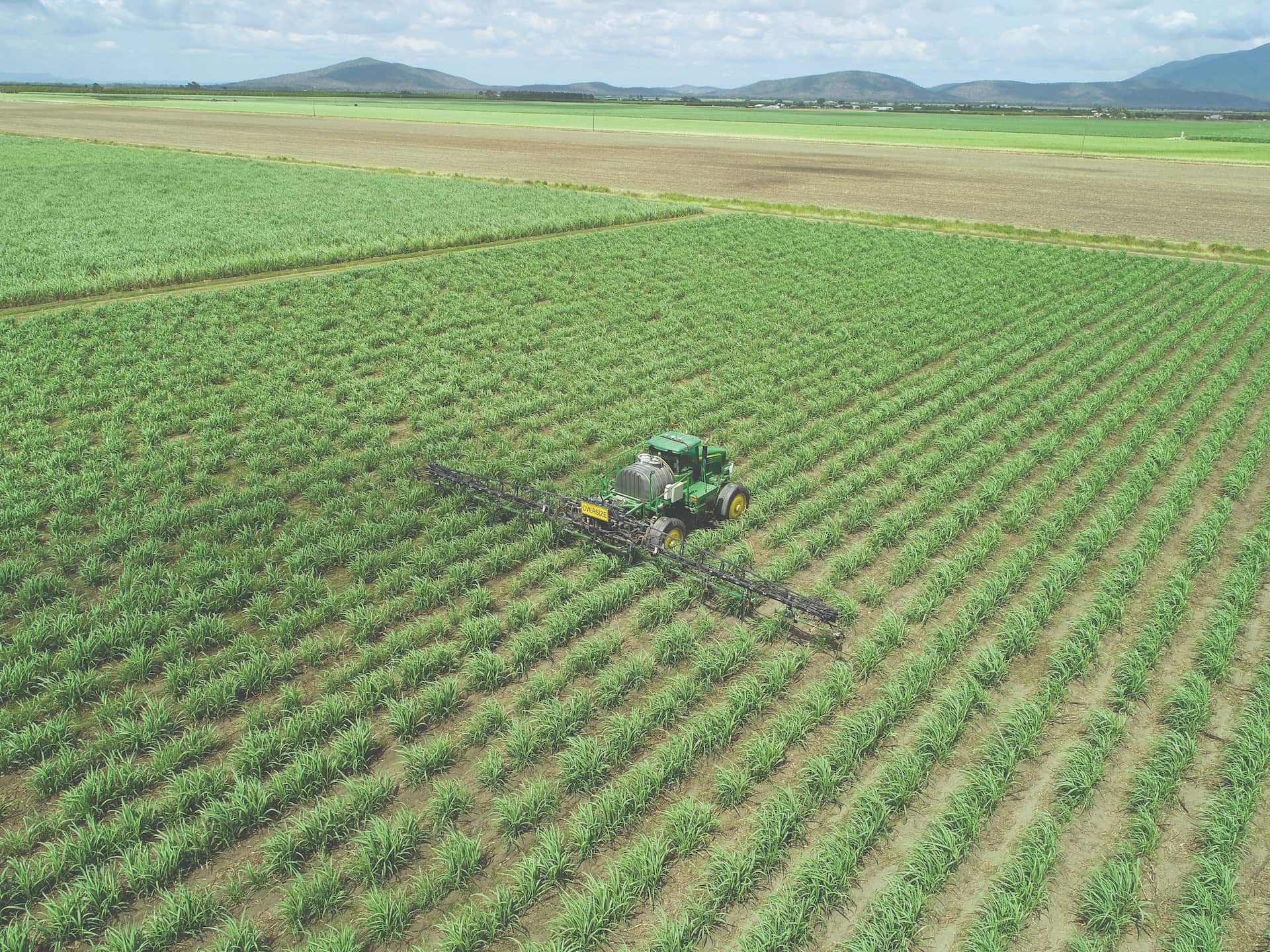 Drone shot of farmer plowing land. 