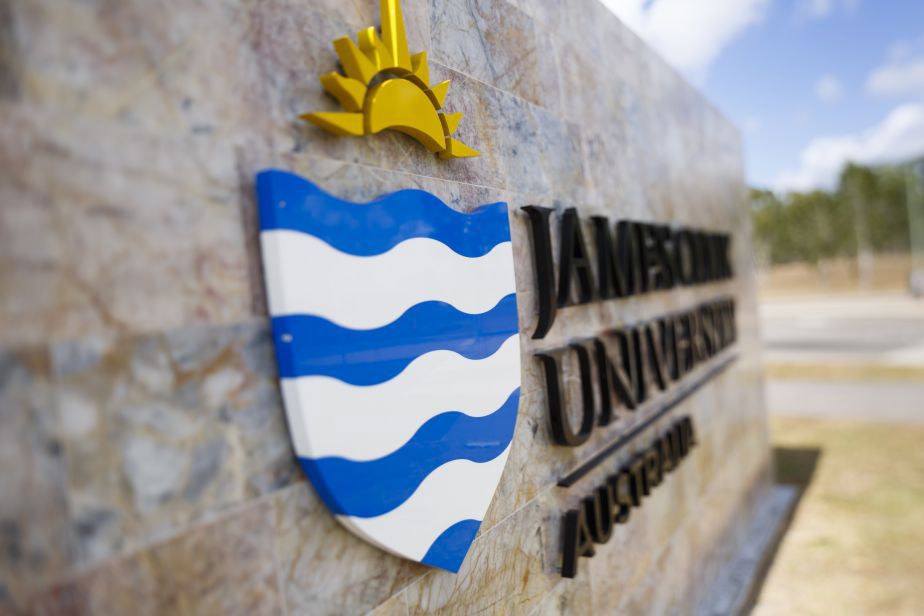 Artistic photo of the JCU logo on the giant entry sign on campus.