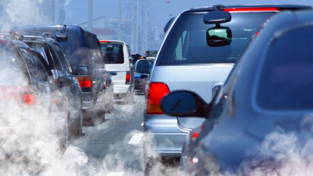 Cars in traffic spewing pollution