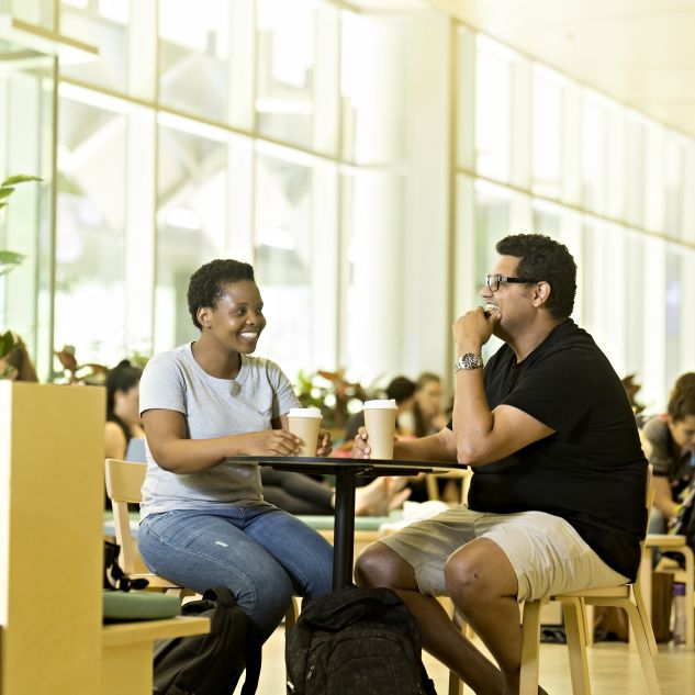 Two international students enjoy coffee together