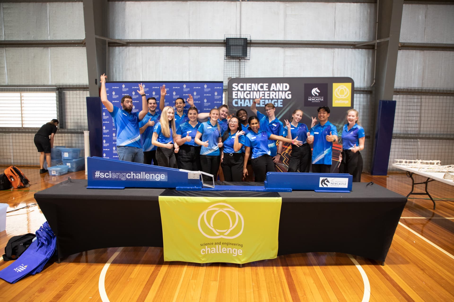 14 JCU Ambassadors posing at a science and engineering challenge. 