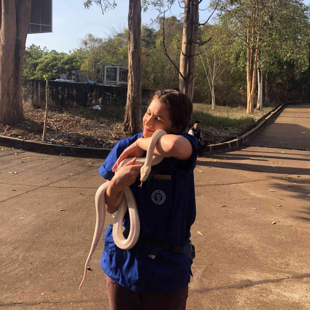 JCU veterinary science student Isabella Sorrentino holding a white snake in her arms. 