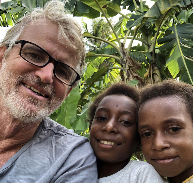 JCU Associate Professor Jeff Warner with Indie and Elizabeth, children of Daniel Pelowa, Jeff’s close friend and colleague who he trained in the lab in the 1990s. PICTURE: Jeff Davis