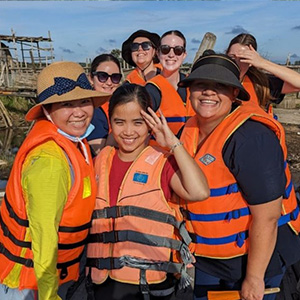 A group of JCU Nursing students with locals, all wearing high visibility clothing