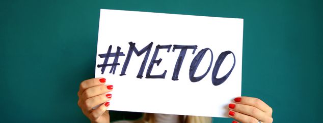 A woman holds a #MeToo placard