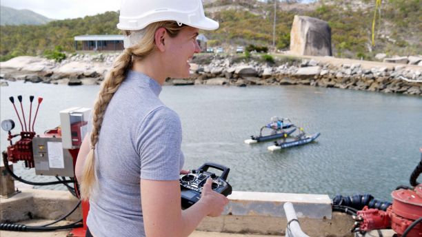 Melanie Olsen operating a water drone. 