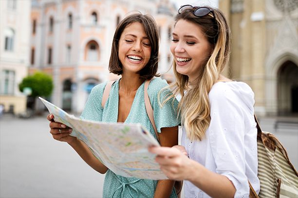 Happy tourists looking at a map