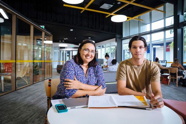 A female and a male student sit at a table in the new Centre