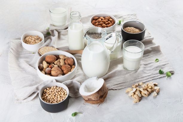 Bowls with nuts and milk in a jug