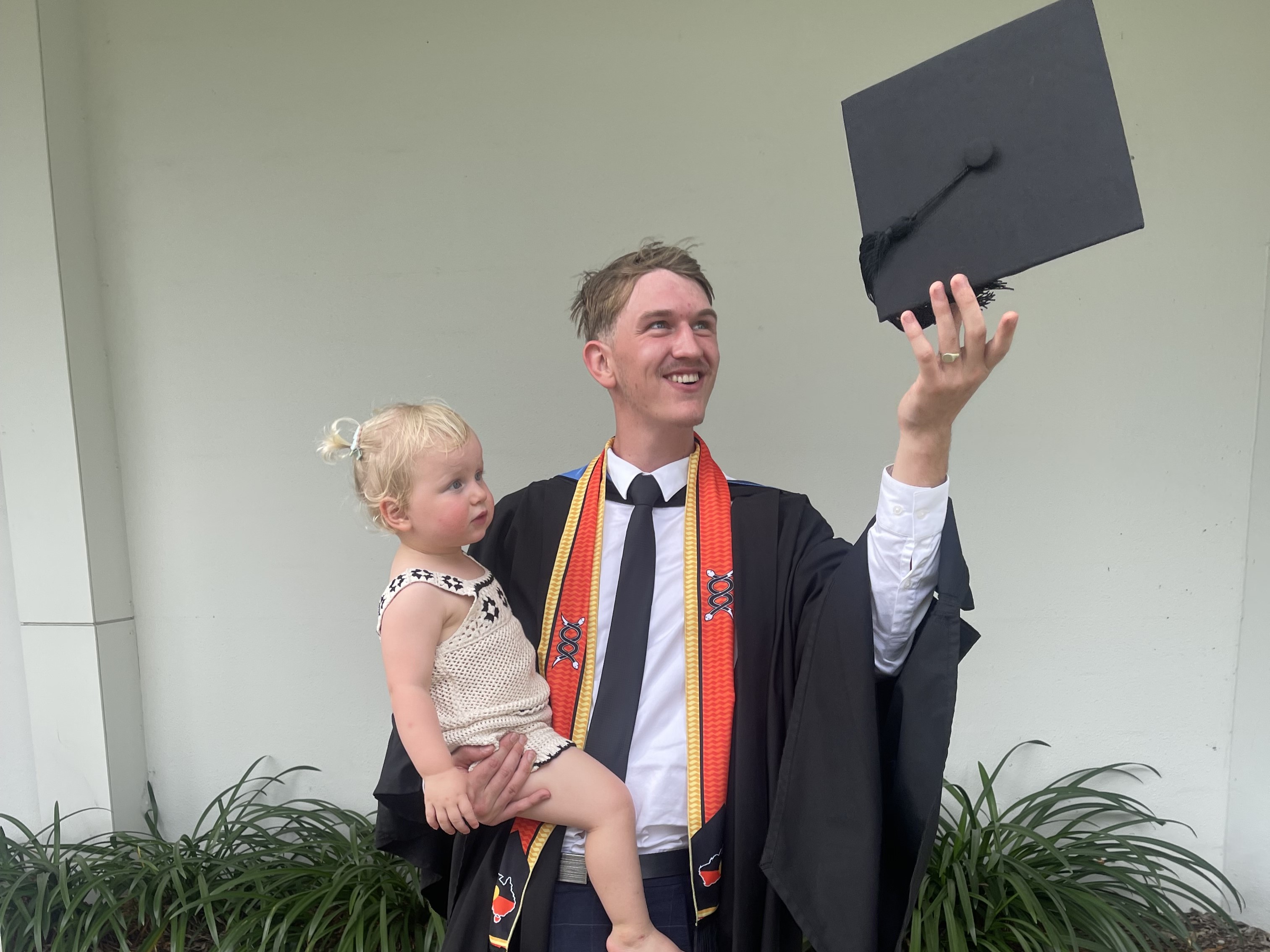 Patrick de Waele throwing cap at graduation