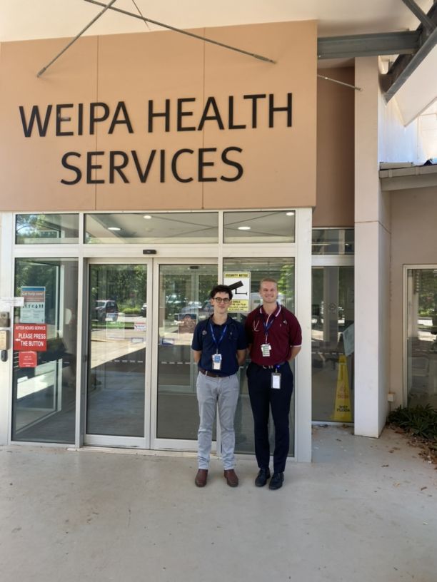 Finley and a fellow student stand outside of the Weipa Hospital. 