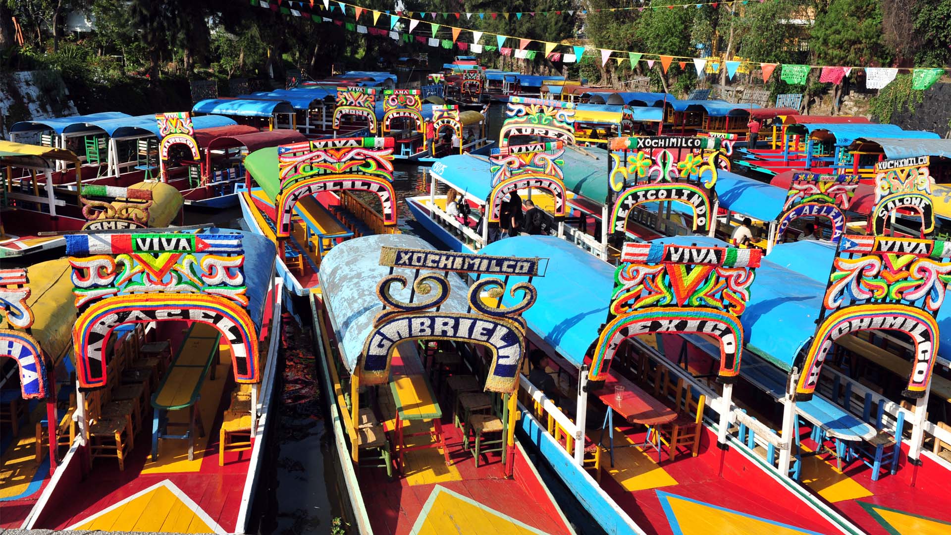 Bright, multi-coloured gondolas fill a canal in Mexico. 