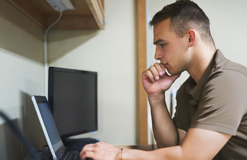 Defence person studying on laptop