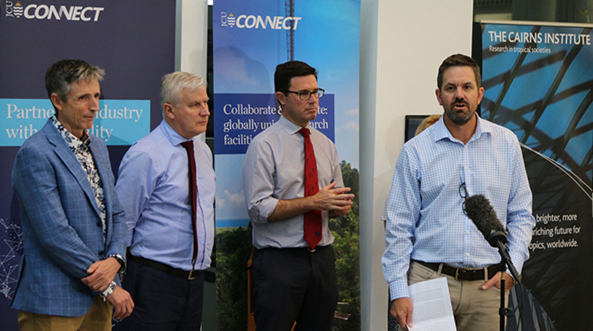 Drought hub director Dan Christie speaking at the launch, with Cairns Institute director Stewart Lockie, Deputy PM Michael McCormack and Minister David Littleproud standing alongside.