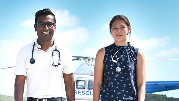 two young doctors in front of helicopter