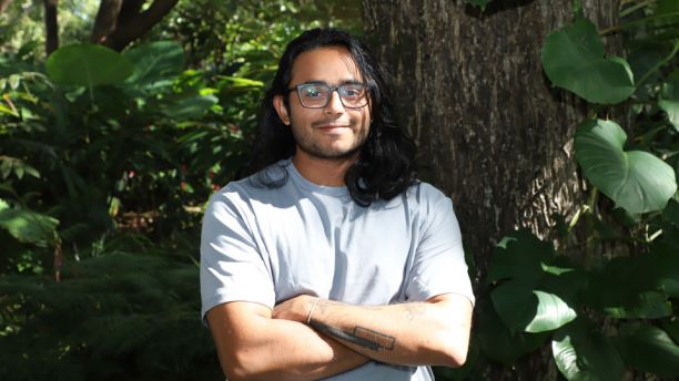 Student Angad Maniyambath in front of tree. 