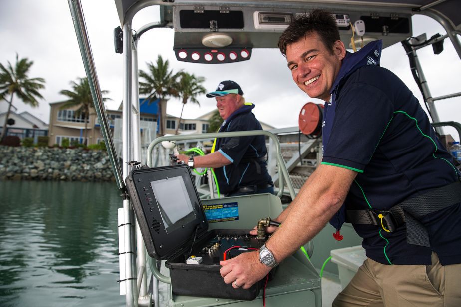 BHERT award winners JCU’s Michael Rasheed (front) and NQBP’s  Kevin Kane on a boat conducting environmental monitoring in Mackay Harbour. 