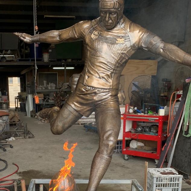 The finished statue of JT kicking a flaming football 