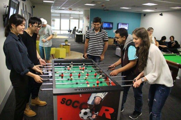 Students playing foosball in the Student Lounge