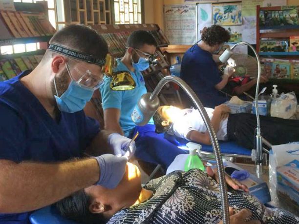 Connor Smith and peers working in a makeshift dental room