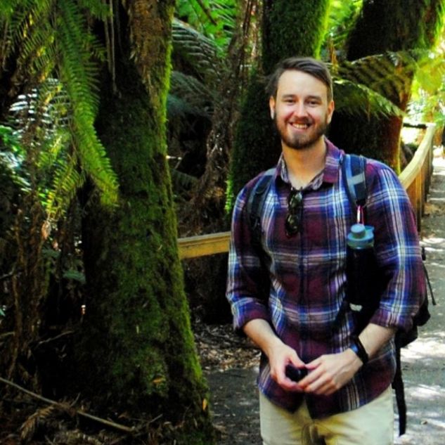 JCU PhD Candidate Jayden Engert surrounded by trees and nature. 