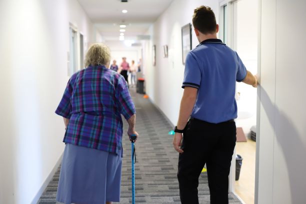 Kieran Jurd walks patient to exercise room. 