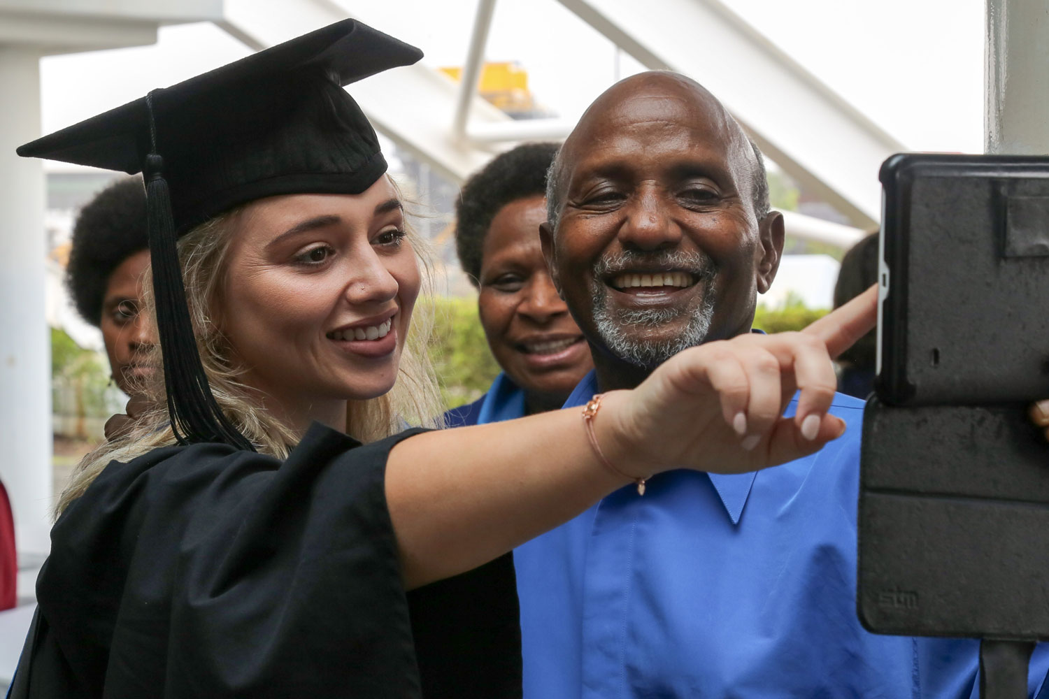 A graduand takes a selfie with one of her guests