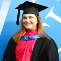 Bachelor of Business Alumni, Brooke Edmonds in her cap and gown at graduation. 
