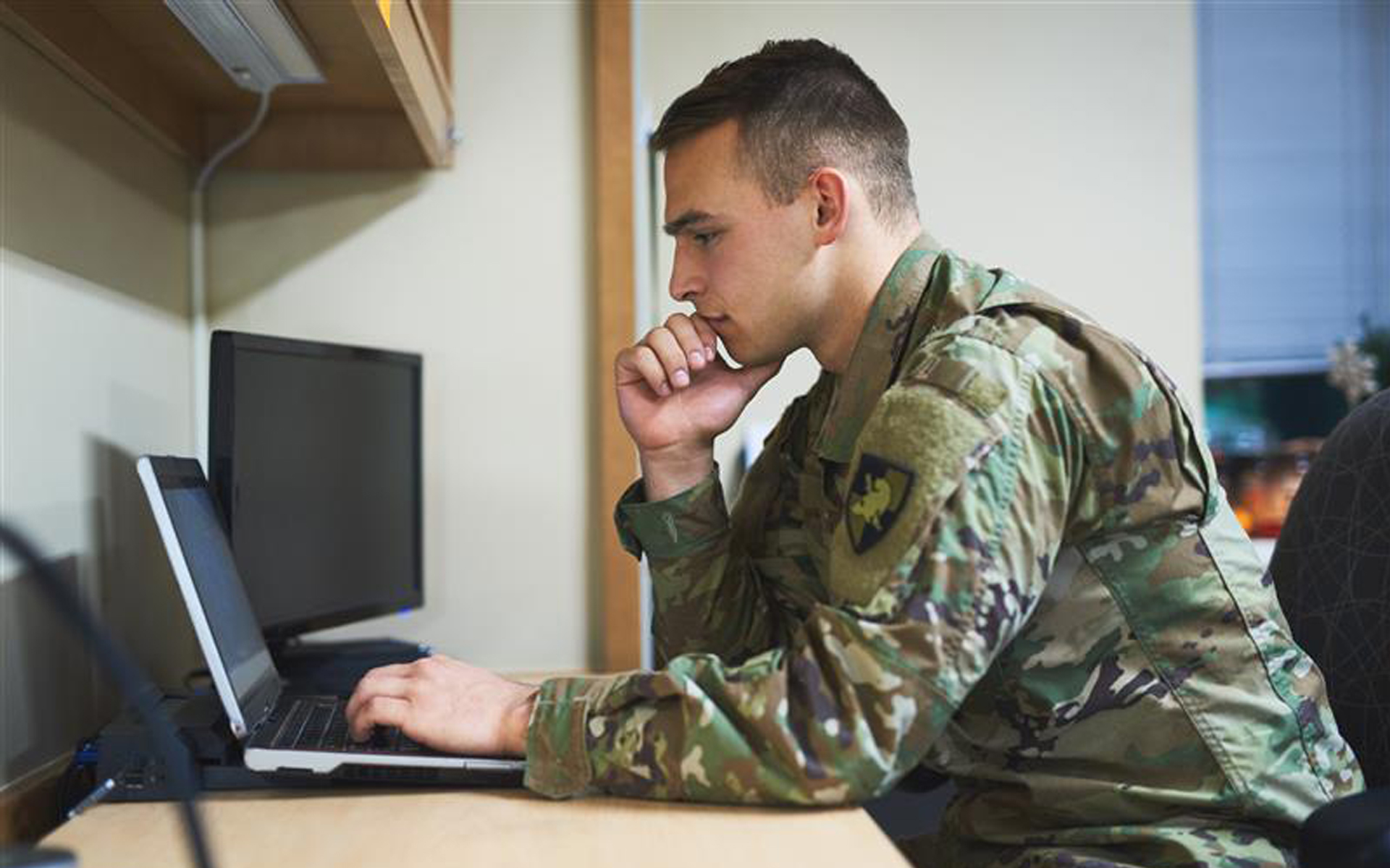 Soldier working on a laptop