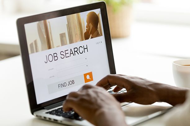 Student on laptop searching jobs