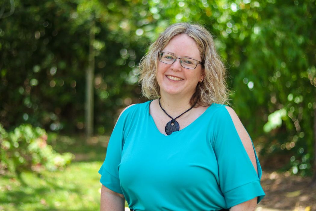 Jodie Maxfield standing by a tree. 