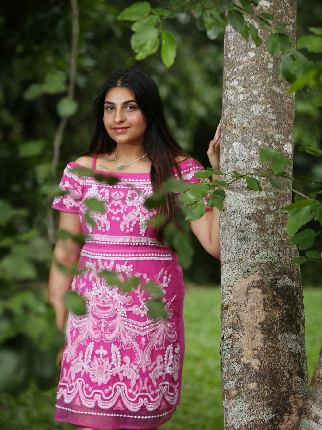 Parneet Kaur standing by a tree.