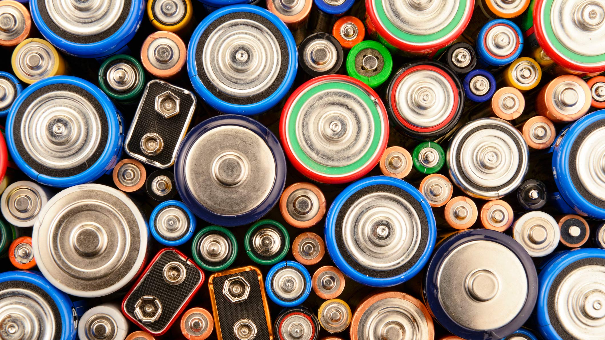 A large amount of colourful batteries grouped together standing up. 