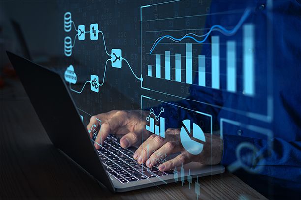 nalyst working with Business Analytics and Data Management System on computer