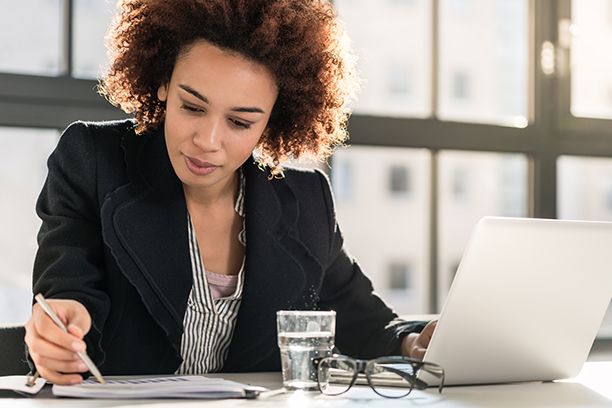 Financial manager analysing printed business report 